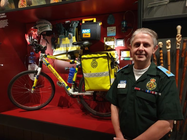 Tom next to his bicycle in the exhibition