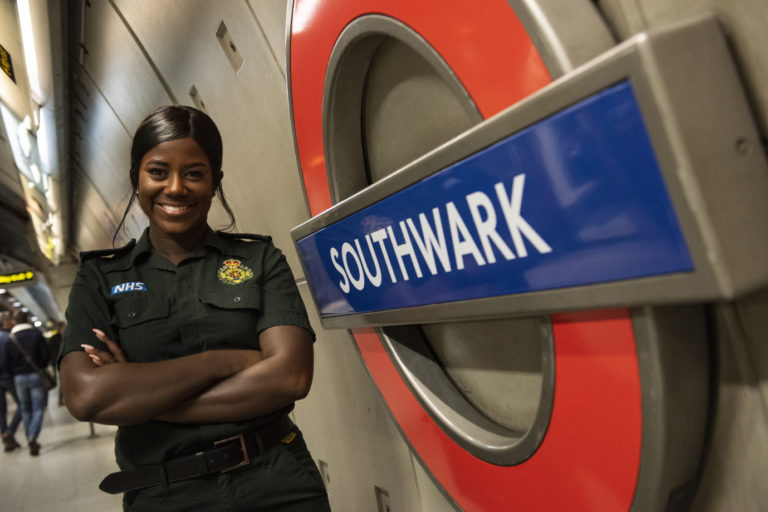 Chaniece Dennis next to Southwark station sign