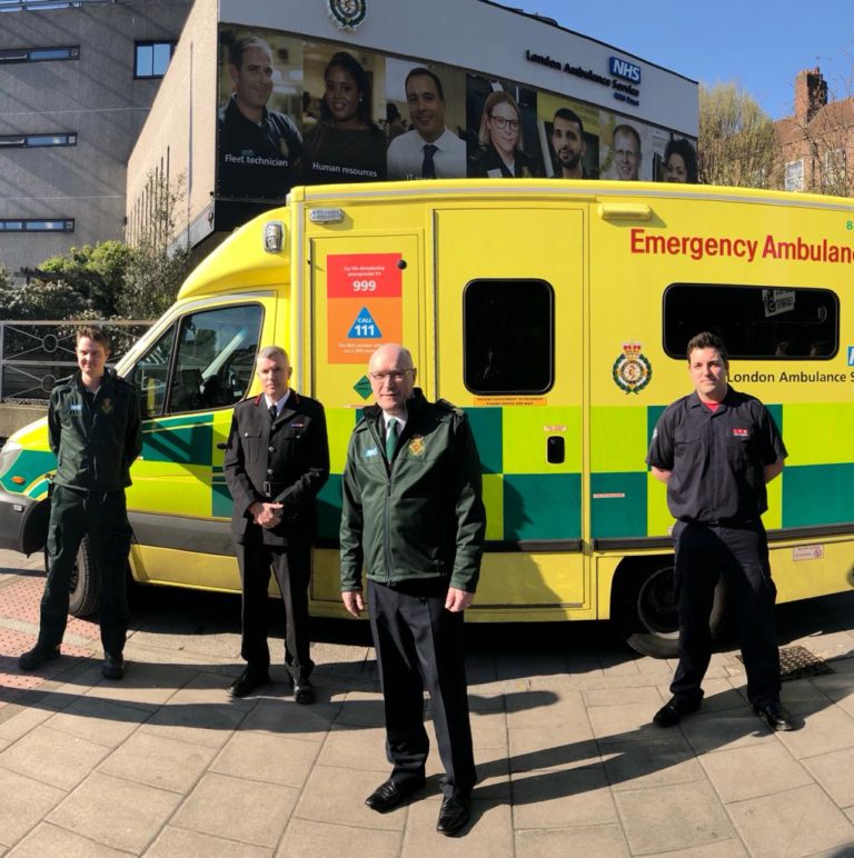 Paramedic, LFB Commissioner, LAS Chief Executive and firefighter stood in front of ambulance
