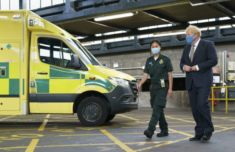 Prime Minister walks past ambulance alongside female medic