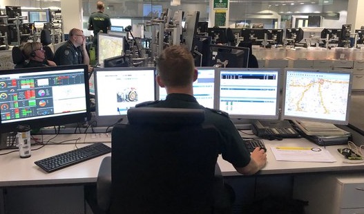 Peter shown from behind at his desk with multiple computer screens