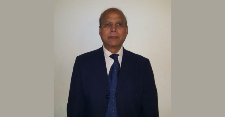 A photograph of Jamil in a suit