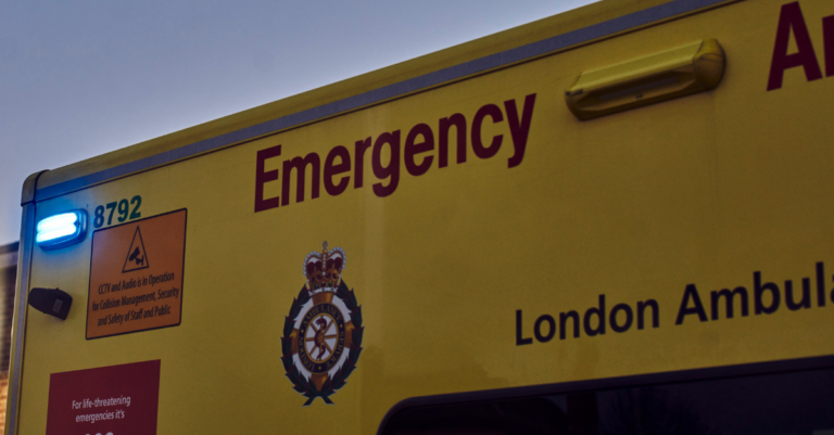 Archive image of the side of a LAS ambulance with the rear blue light flashing