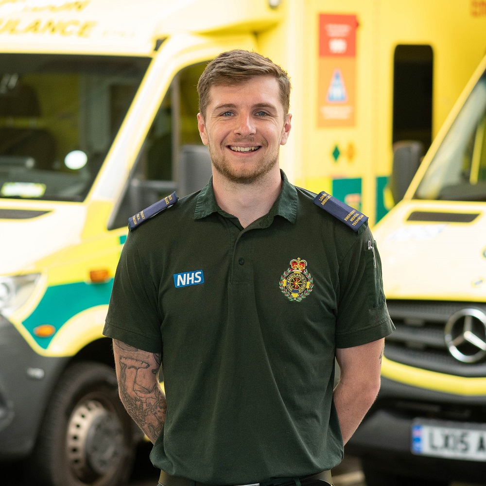 James is an EMT in south west London. He is pictured in front of an ambulance.