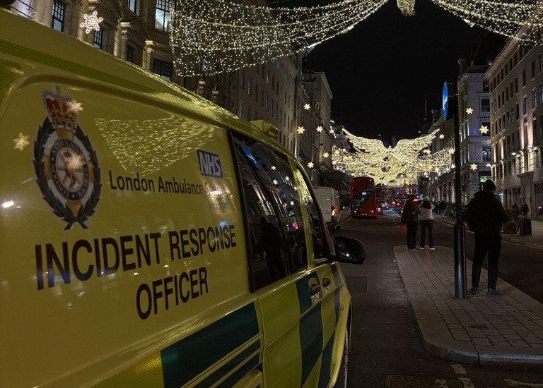 An Incident Response Officer vehicle on Oxford Street with festive lights visible in the distance.