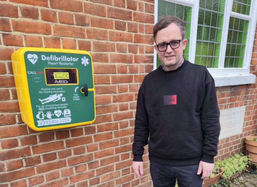 Reverend Stephen Maclean stood by a public-access defibrillator. 