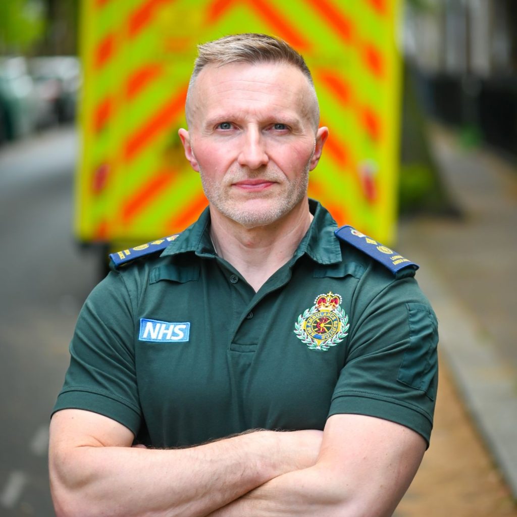 Jason Killens KAM in his operational ambulance uniform, in front of an ambulance.