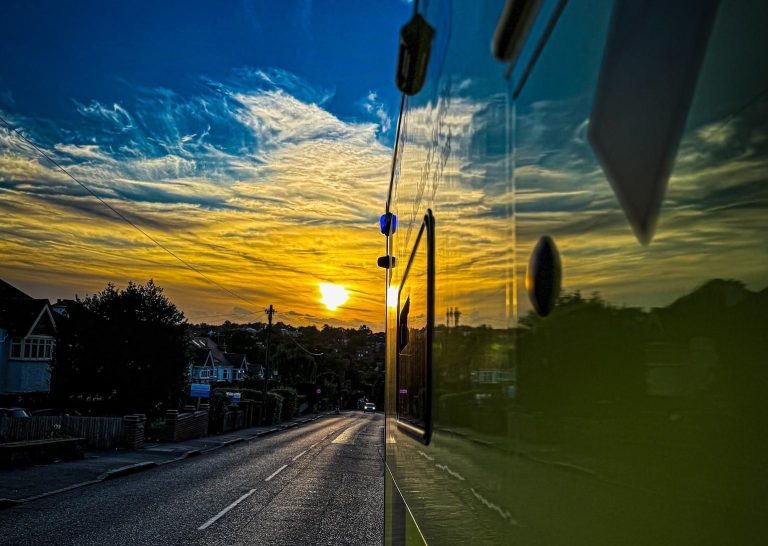 A sunset on a hot day with an ambulance visible.
