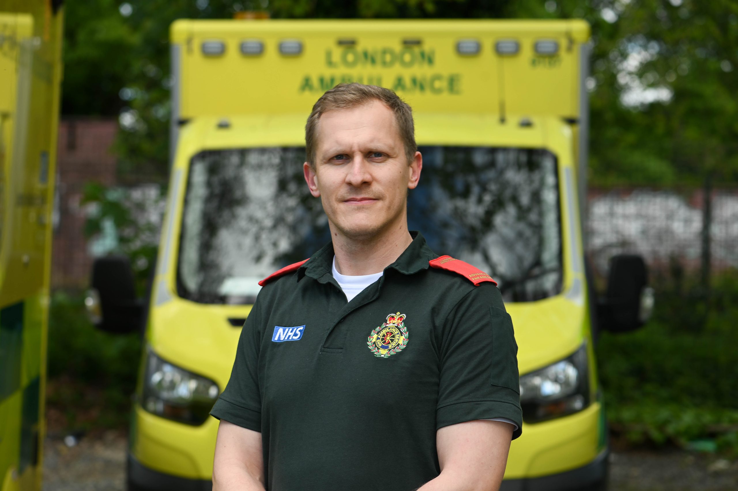 An advanced Paramedic in front of an ambulance.