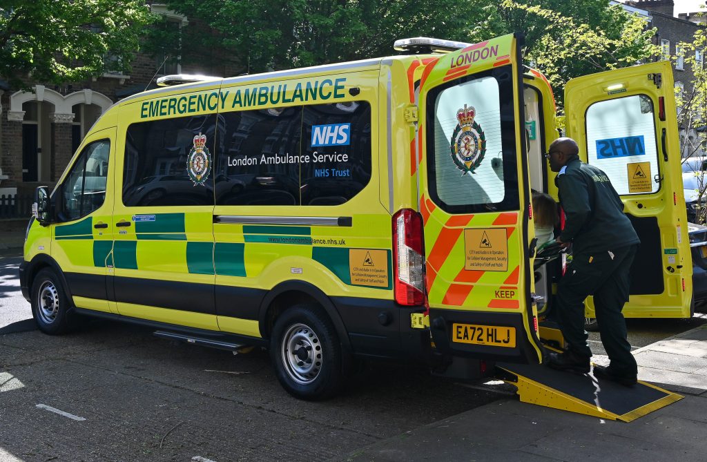 Patient being loaded on to a vehicle by a NETS team member.