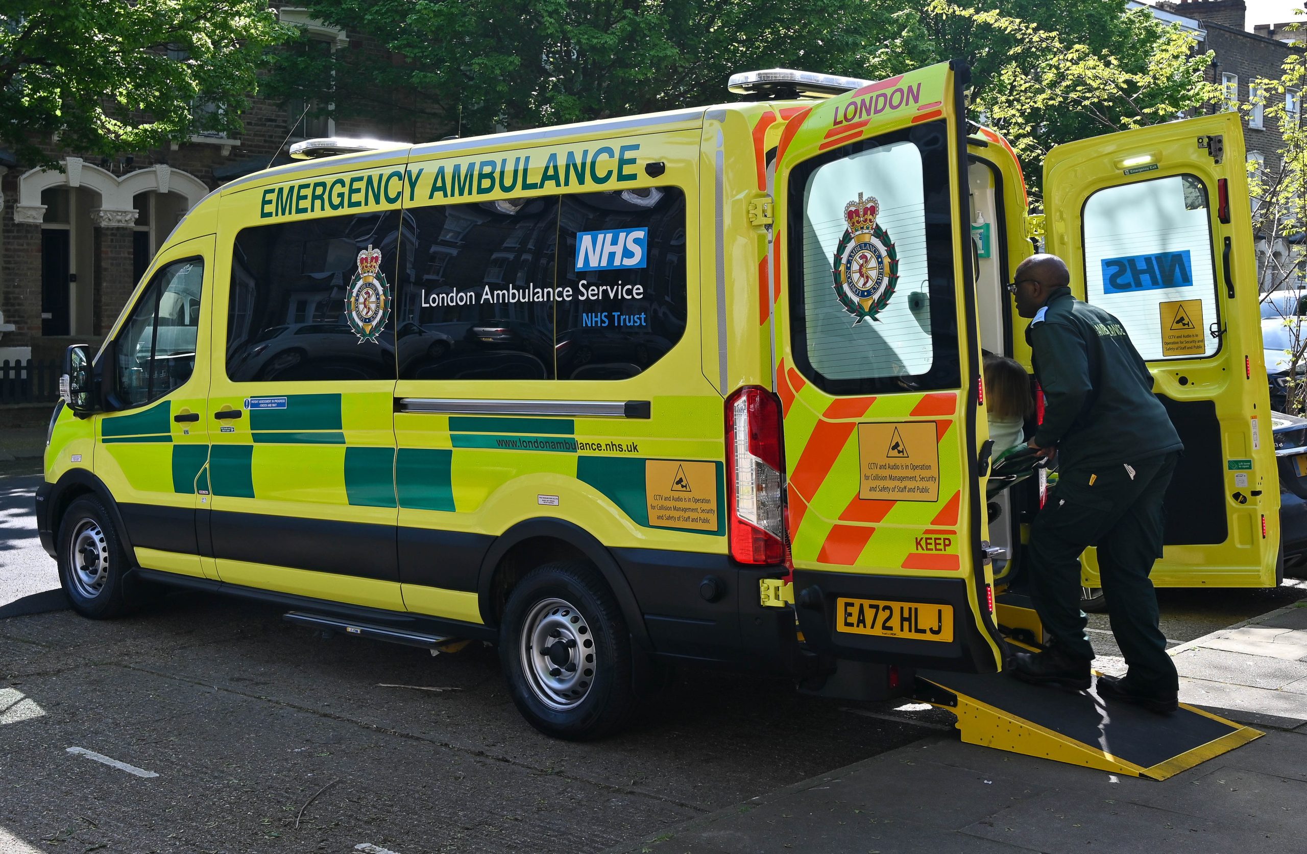 Patient being loaded on to a vehicle by a NETS team member.