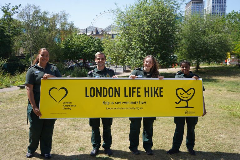 Staff holding a London Life Hike banner