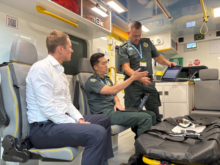 James Frith MP receiving a demo from London Ambulance Service clinicians inside an ambulance.