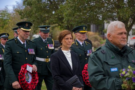 London Ambulance CEO Jason Killens holding a wreath at TASC Memorial