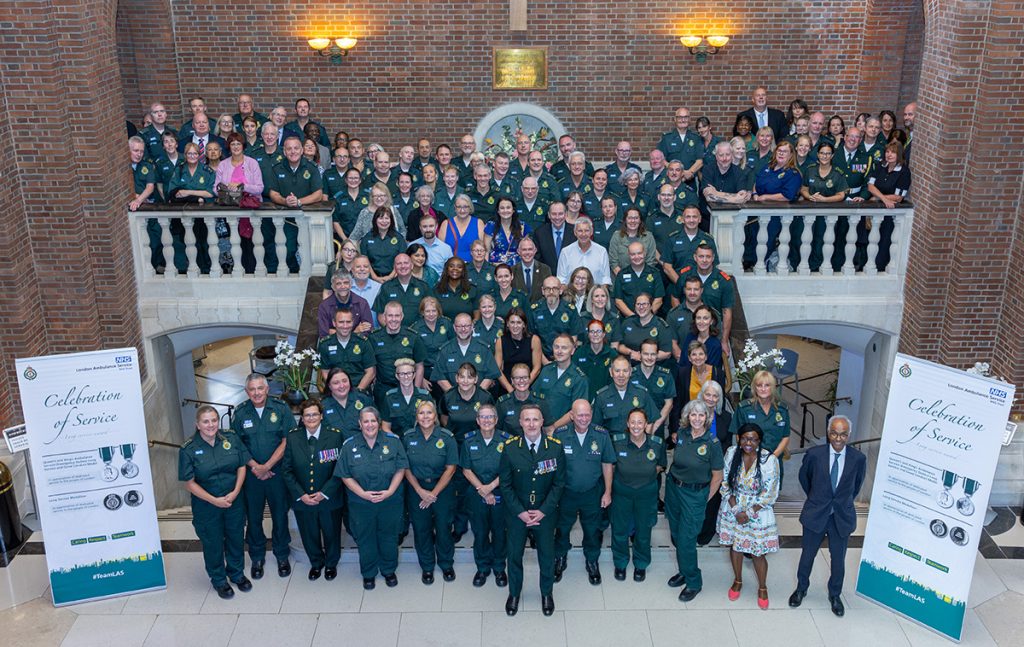Attendees of the service posing for photo on stairs