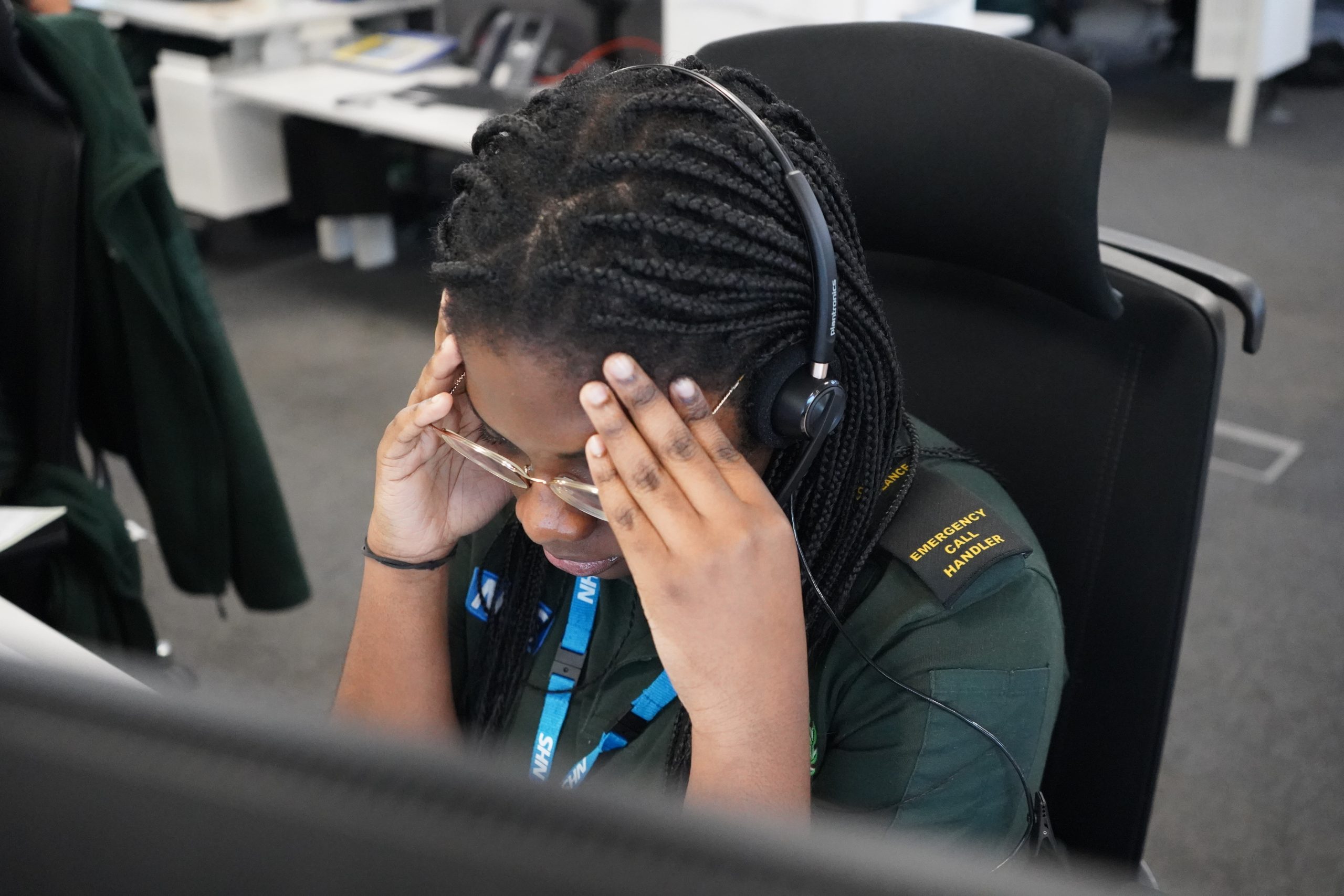 Call handler with head in hands.